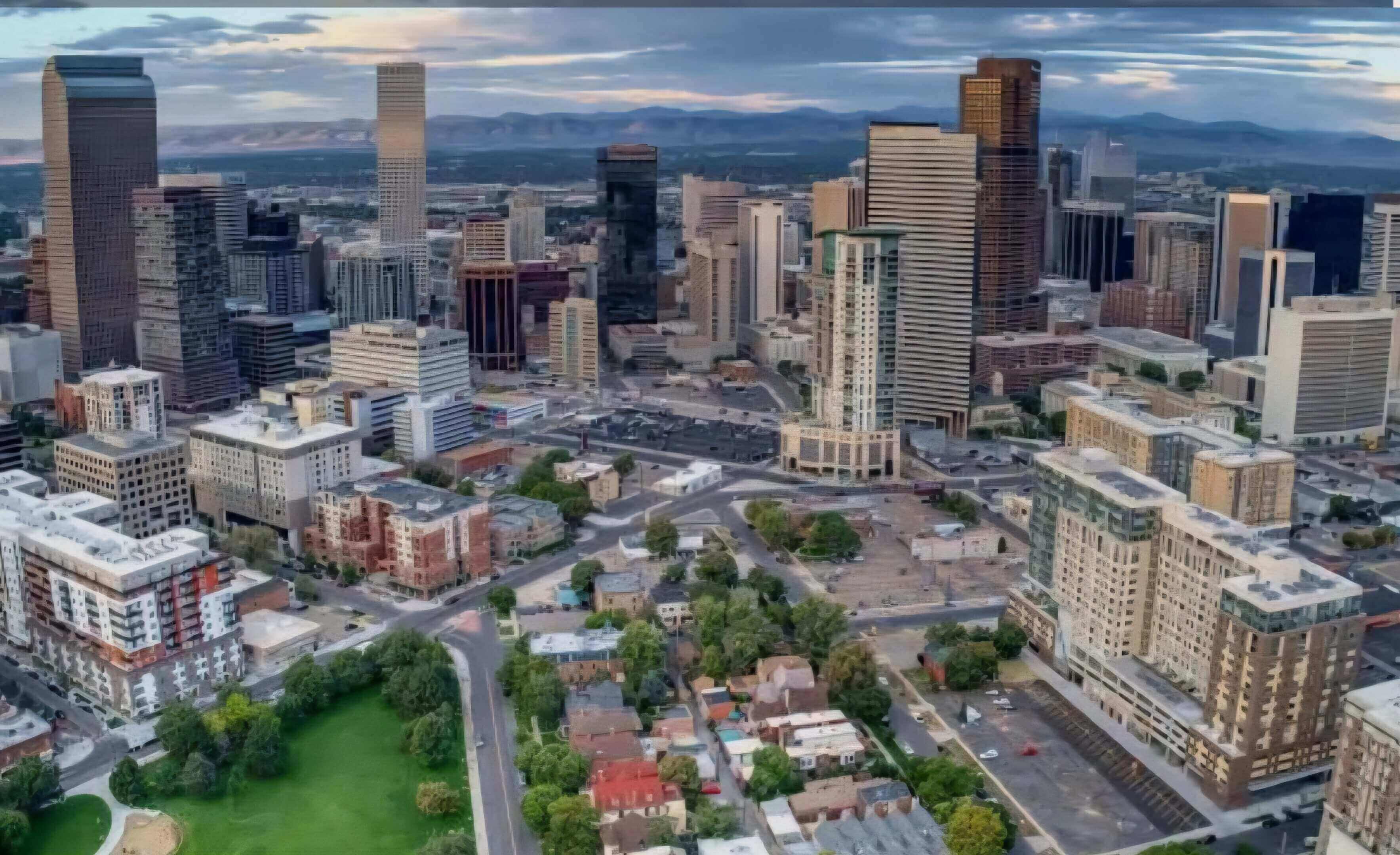 Aerial view of a city skyline with tall buildings and residential areas.